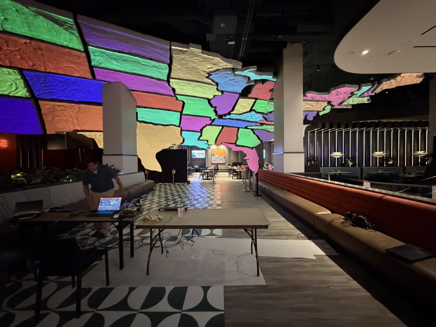 Irregular ceiling surfaces filled with colorful projection inside a restaurant.