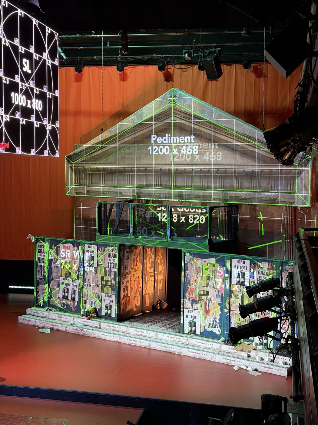 Calibration patterns and imagery mapped across a house-shaped scenic structure.