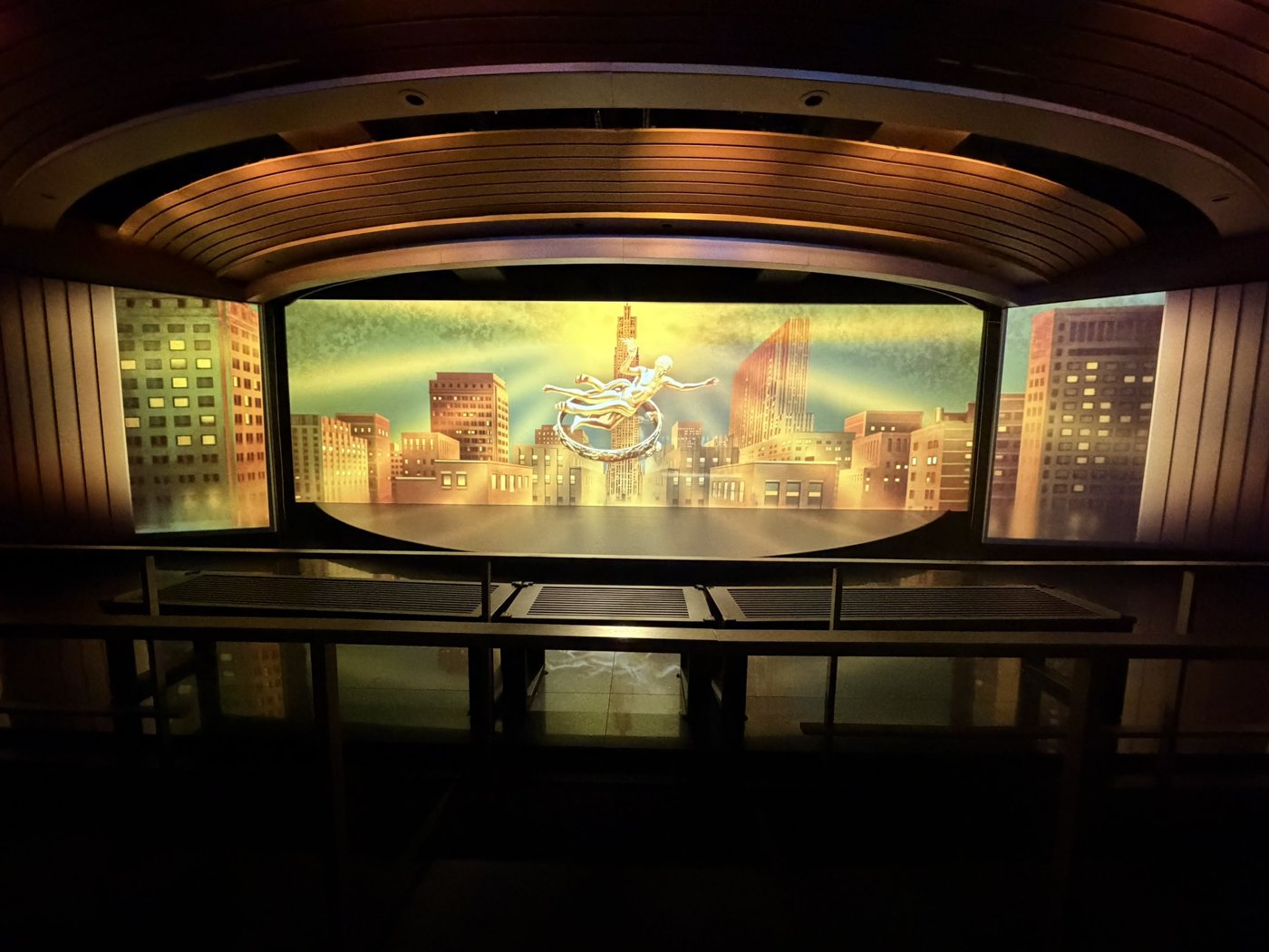 A curved golden display set into an architectural surround.