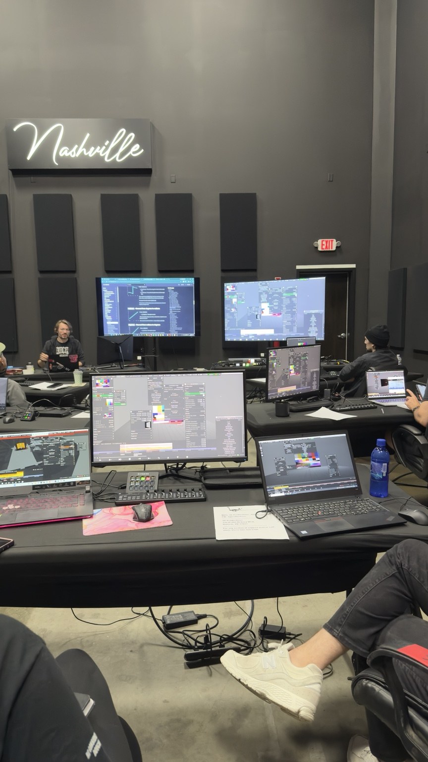 Tatton teaching a classroom of participants working at disguise computers in Nashville.